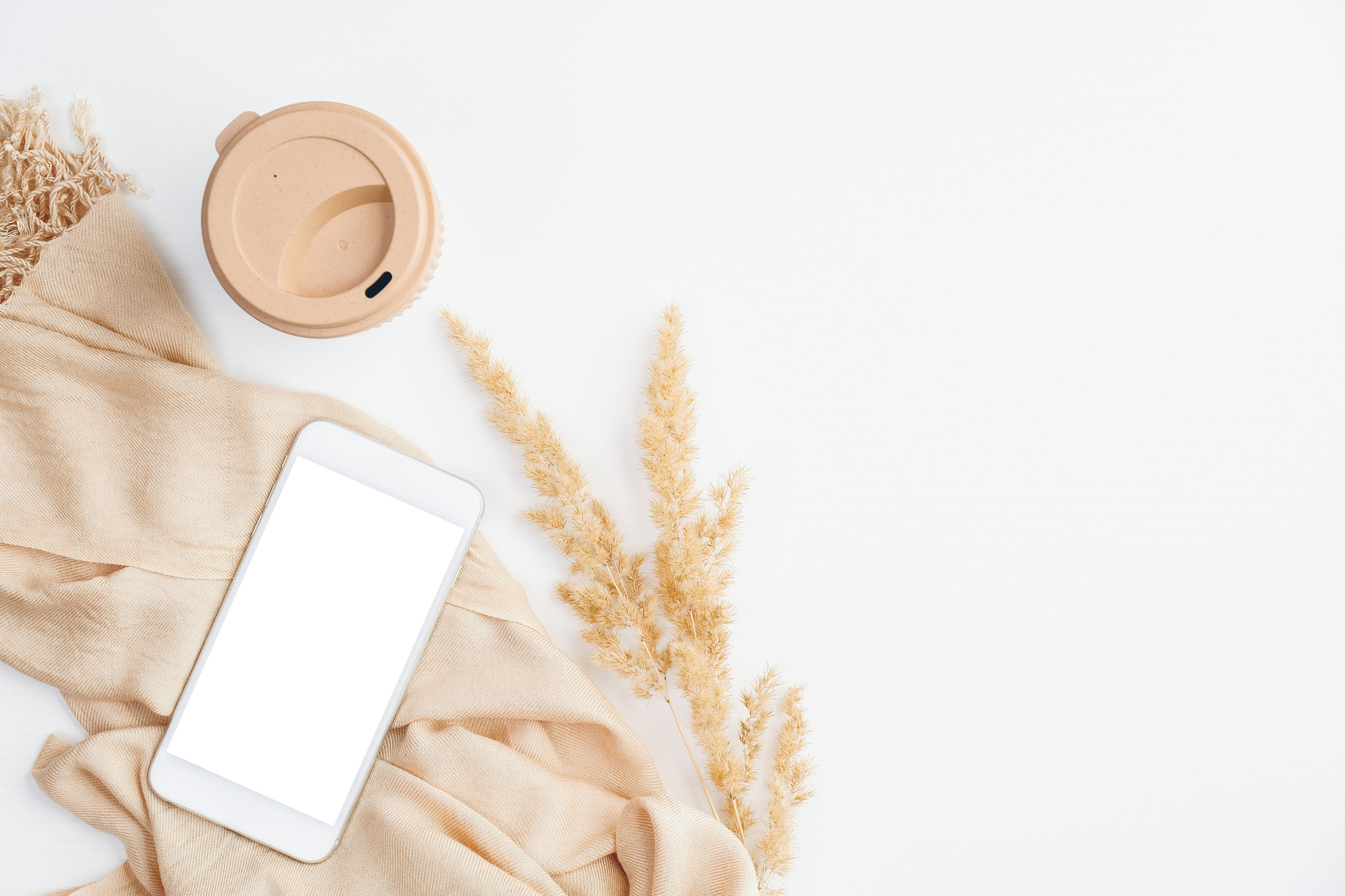 Beige Blanket, Flower, and Coffee Cup Flat Lay